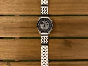 Omega x Swatch MoonSwatch with zamani Classic Keffiyeh band on wood deck