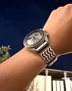 MoonSwatch with zamani Classic Keffiyeh band on wrist at evening